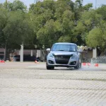 Drive a car safely through complex urban environments.
