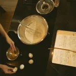 Run a robotic arm through a cooking recipe in a controlled kitchen.