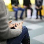 lead a group therapy session with emotional support for participants
