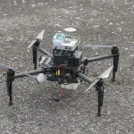 autonomously pilot a drone through dense urban environments using only onboard cameras?